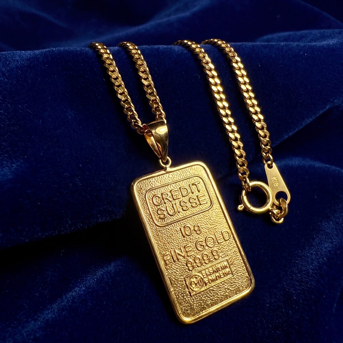 Credit Suisse Gold Bar Pendant Necklace — photograph 1